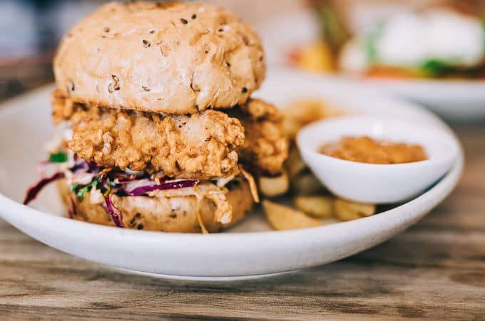 A bulging chicken burger with slaw and triple cooked chips at The Borrowed Table